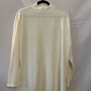 Creamy white ribbed turtleneck sweater with side slits